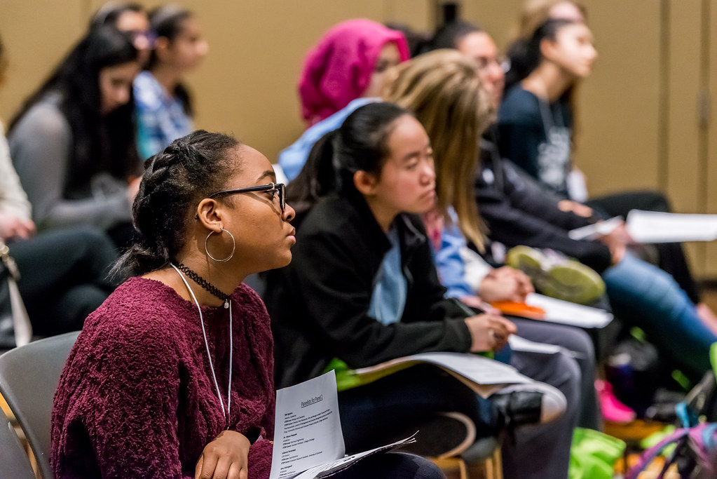 first-generation college student image; collegeadvisor.com: two BIPOC female students in frame attend a college lecture