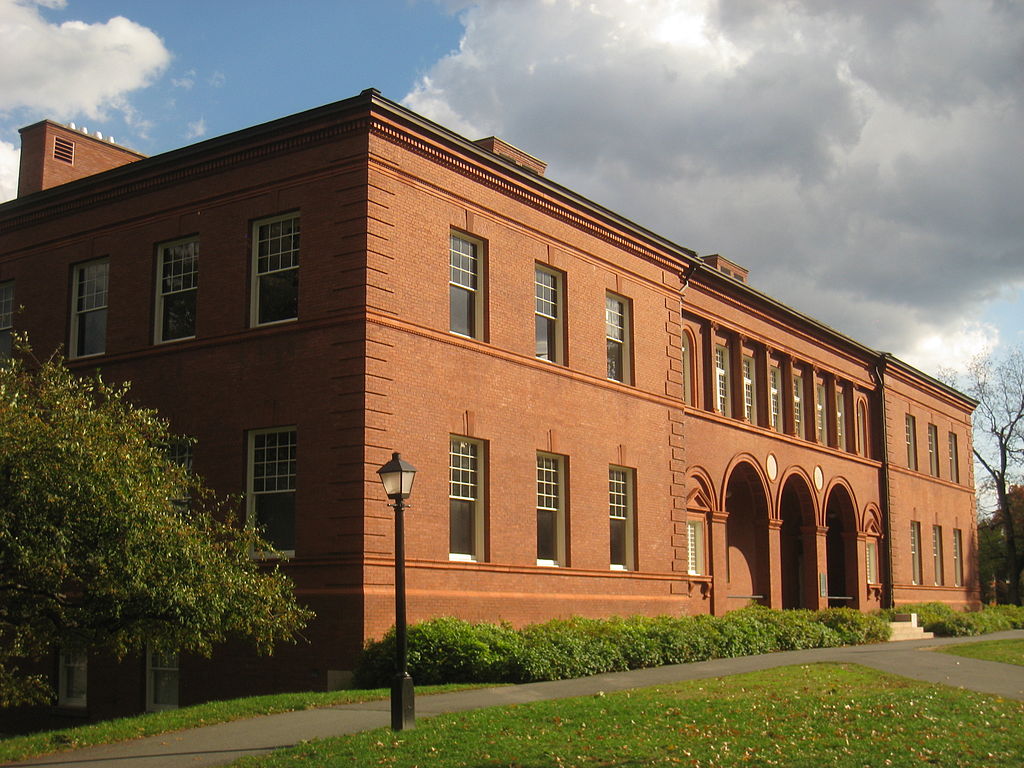Amherst supplemental essays; collegeadvisor.com image: a photo of an Amherst campus building with a cloudy sky