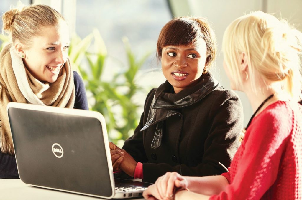 UPenn Huntsman Program image; collegeadvisor.com; three female students studying in front of a Dell laptop